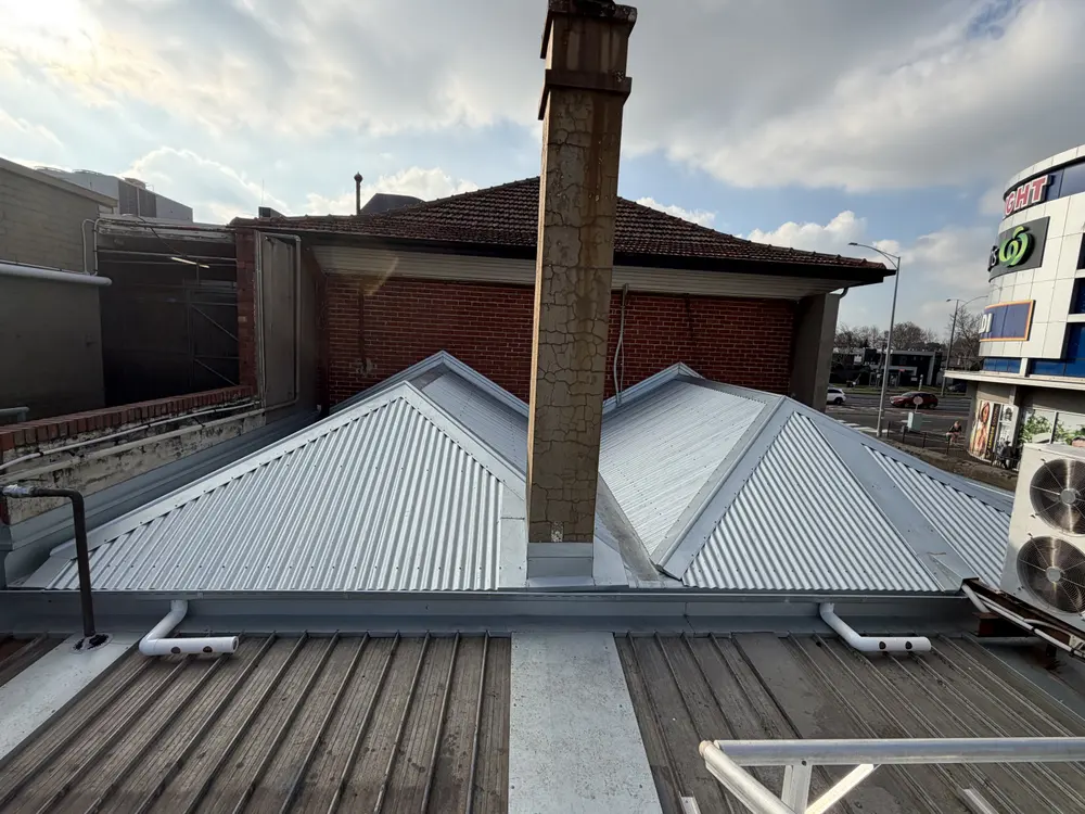 The same shopfront after the tiles were replaced with metal roofing