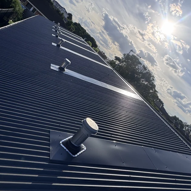 Close view of new Colorbond sheets and roof vents on a Melbourne roof